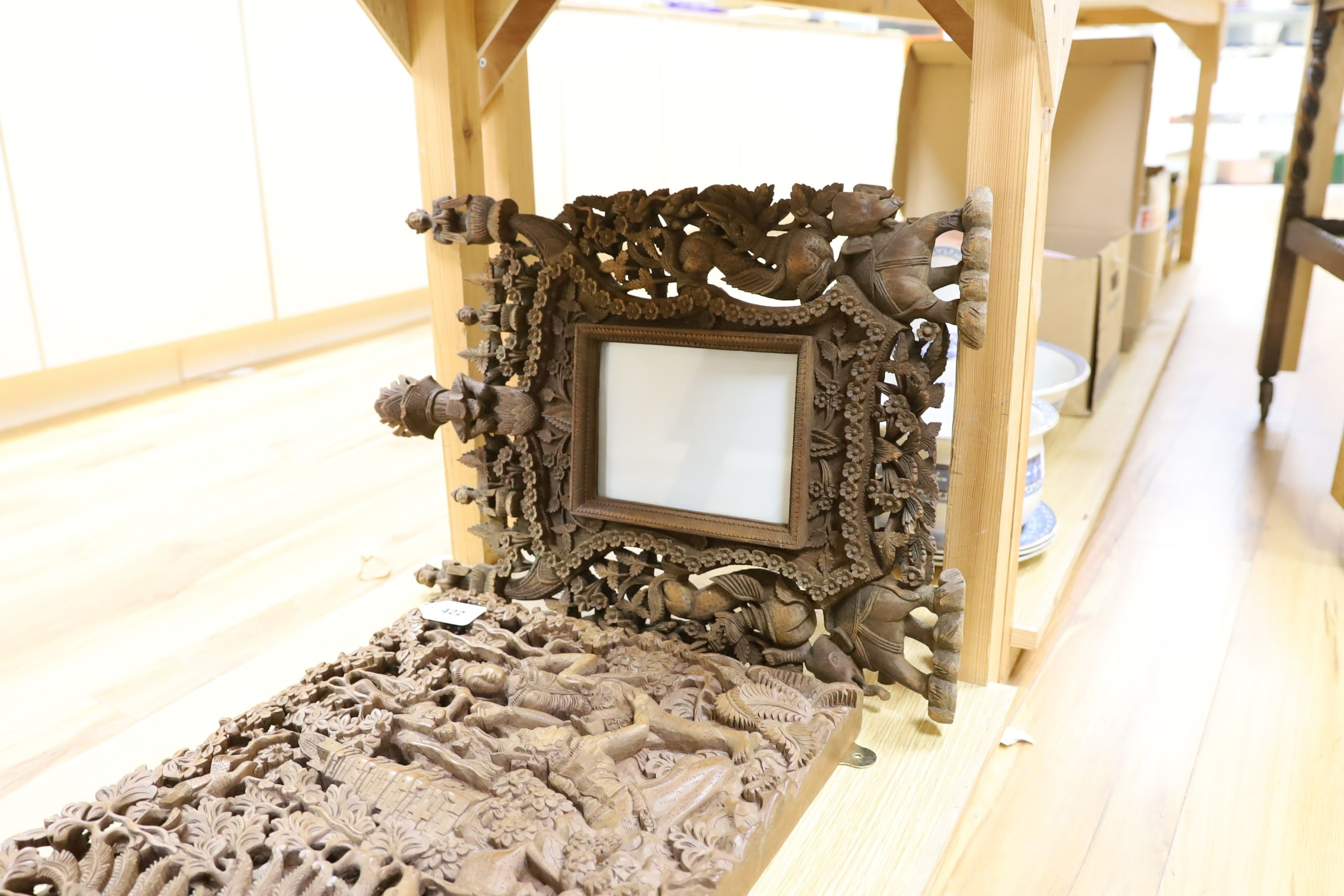 A Burmese or Indonesian graduated carved wall hanging what not, similar frame and carved panel